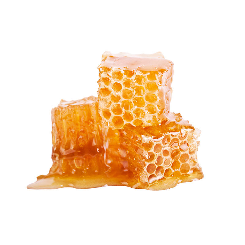 Several cubes of honeycomb, made of beeswax, covered in honey 