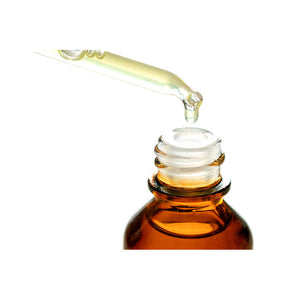 Hydrating vitamin E oil in a dropper being dropped into a bottle